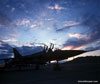 Photo of military jet on runway at dawn